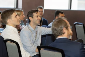 Picture of a small crowd of people sitting and smiling